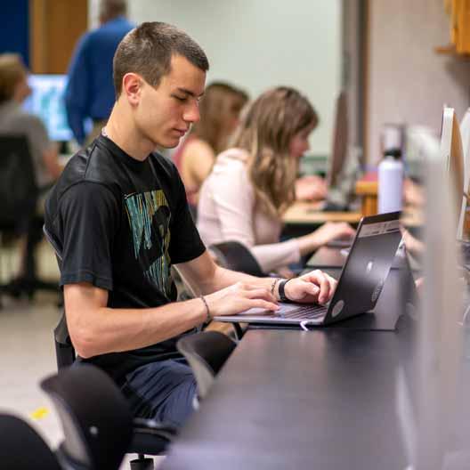 A student works on a laptop in class